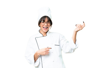 Young caucasian chef  woman over isolated chroma key background making guitar gesture