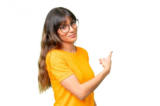 Young caucasian woman over isolated chroma key background pointing back