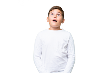 Little caucasian kid over isolated chroma key background looking up and with surprised expression