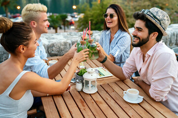 Leisure holidays vacation people and food concept. Happy friends having dinner at summer party