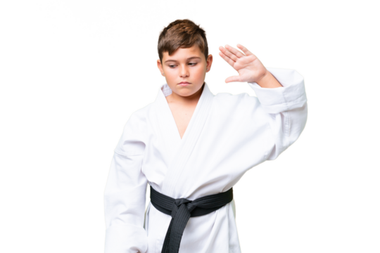 Little caucasian kid doing karate over isolated chroma key background making stop gesture and disappointed