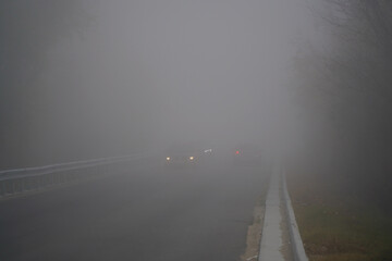 the fog. road traffic during fog. reduced visibility.