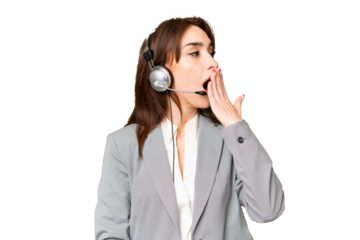 Telemarketer caucasian woman working with a headset over isolated chroma key background yawning and covering wide open mouth with hand