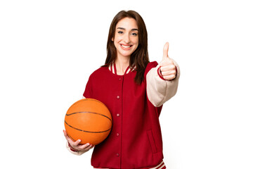 Young basketball player woman over isolated chroma key background with thumbs up because something good has happened