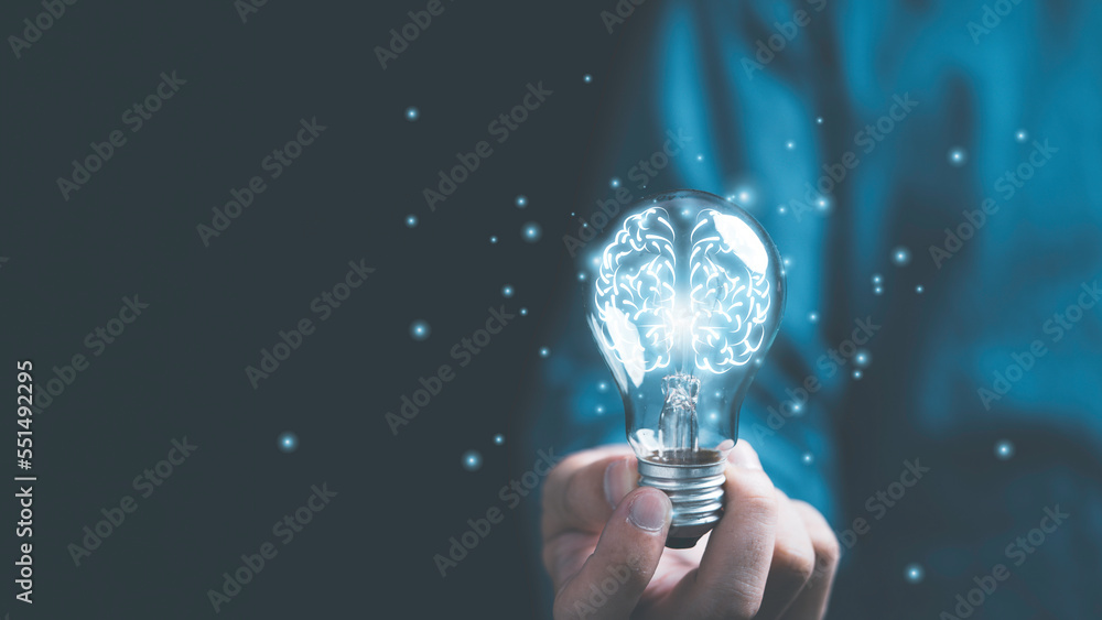 Poster businessman hand holding lightbulb with glowing virtual brain and connection line to creative smart 