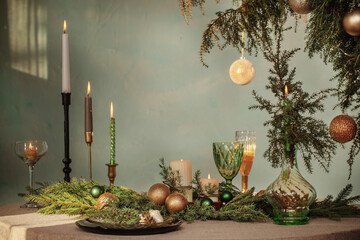 green and golden christmas decor on table on dark background