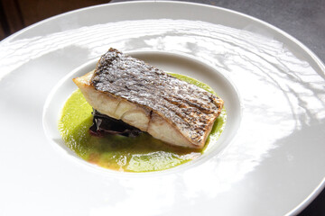 slice of roasted swordfish on vegetable cream