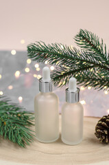 Bottle of essential oil or serum on Christmas background. Blank for christmas sales