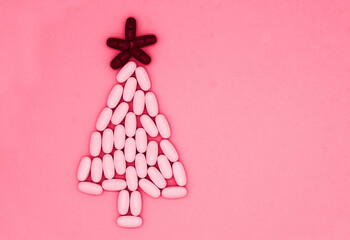 White, red medical pills in form of Christmas tree on blue background with copy space. Christmas medical flatly.. viva magenta