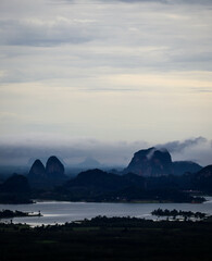 misty morning over the lake and limestone hill