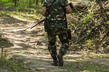 Fototapeta premium Fully Equipped Soldiers Wearing Camouflage Uniform Attacking Enemy.