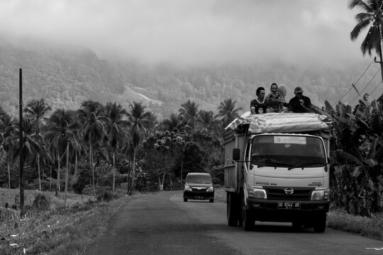 Grayscale shot of cars on AKD Road Kotamobagu, North Celebes, Indonesia