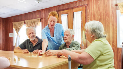 Group of seniors playing dominoes with support