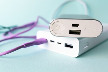 Power bank, external battery and usb wire on the table, universal mobile battery for charging...