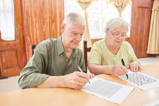 Pair of seniors solving puzzles as memory training