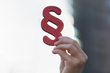 Hand of businesswoman holding paragraphy symbol as law concept