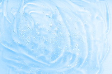 Hyaluronic acid fluid skincare product with bubbles. Blue jelly sanitiser abstract pattern, cleansing emulsion macro.