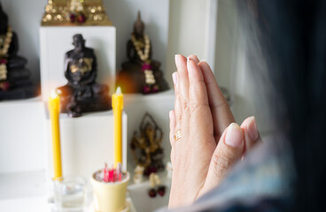 Close up of hands religious Asian buddhist woman praying