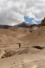 A lone climber walking in the mountains with backpacks. Small Himalayas 