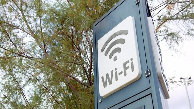 Wi-Fi sign in public place for use on pole. Wi-Fi inscription on stele in city park for everyone to use. Distribution of Internet.