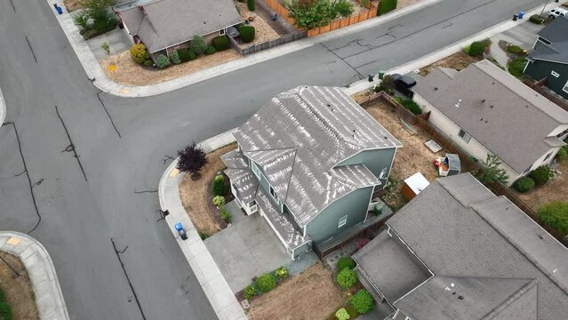 Drone shot of zinc moss preventer spread across the roof of a house.