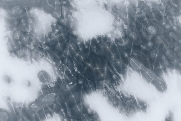 A body of water covered with textured ice. Top view. Winter background.