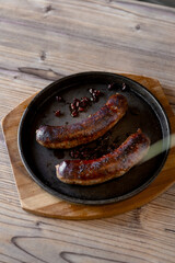 grilled sausages on a wooden background