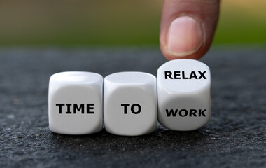 Hand turns dice and changes the expression 'time to work' to 'time to relax'.