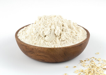 Organic oatmeal flour in a wooden bowl on a white background. The concept of gluten free food. Baking ingredients.