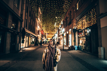 Girl in Winter lights Christmas market in the center of Luxembourg city