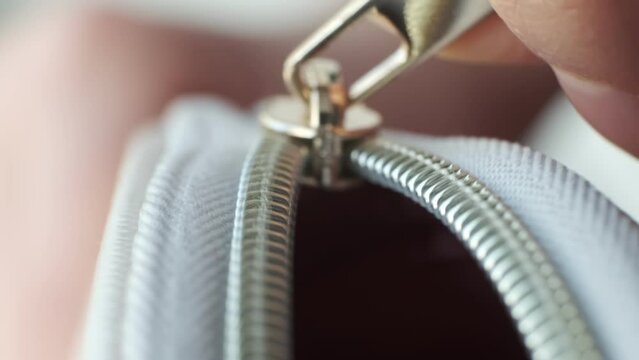 Selective focus, yellow metal zipper of a makeup bag or small purse macro pattern background