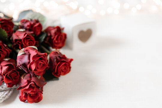 Festive background for Valentine's Day with a bouquet of red roses, copy space.