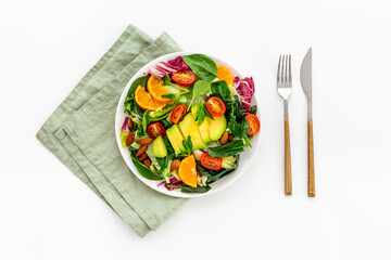 Healthy vegetarian bowl of green salad with avocado and tomatoes