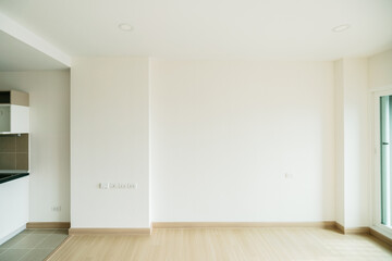 Fototapeta na wymiar Empty room is decorated with an engineering wooden floor with baseboard and wallpaper on the wall with sunlight from the window. Minimalist interior design and real estate for decoration. Real image.