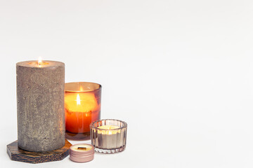 Burning candles on a white background isolated.