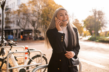 Smiling cute woman talking on the phone