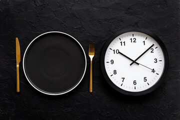 Time to eat - meal time concept. Round wall clock with plate