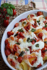 Italian baked pasta PACCHERI con tomatoes, mozzarella and fresh basil