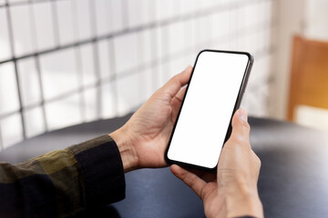 cell phone blank white screen mockup.hand holding texting using mobile on desk at office.background empty space for advertise.work people contact marketing business,technology