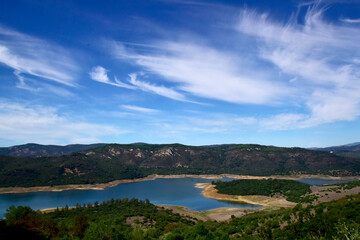 picturesque lake between rocks under blue sky