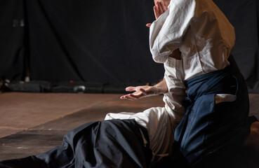 .Opponent knockdown and immobilization. Black belt aikido master during a training session. .