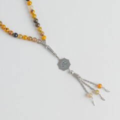 A yellow metal Misbaha with arabic name 
 