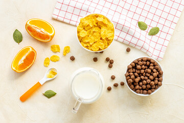 Children breakfast with snack - cereals with oranges, top view