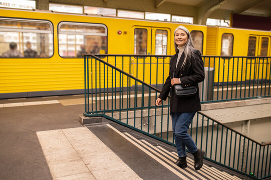 Woman In A Black Coat Walking Out Of Subway