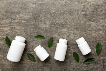 supplement pills with medicine bottle health care and medical top view. Vitamin tablets. Top view mockup bottle for pills and vitamins with green leaves, natural organic bio supplement, copy space