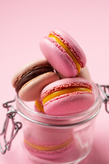 Pink Strawberry and Chocolate French macaroons on Pink Background.