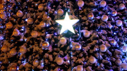 Part of the decoration of a Christmas tree covered with snow. Background festive decoration
