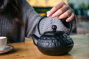 Cast iron black Turkish teapot close-up on the table.