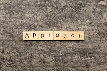 APPROACH word written on wood block. APPROACH text on cement table for your desing, concept