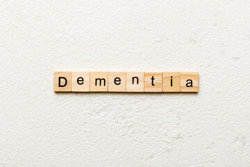 Dementia word written on wood block. Dementia text on cement table for your desing, concept